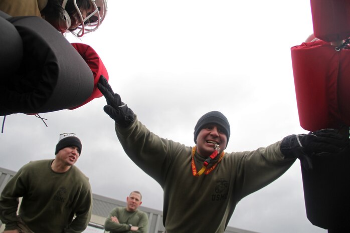 Sgts. Daniel Zevnik, 27, from Milwaukee, Wis., and Tony Kaiser, 30, from Eau Claire, Wis., motivate two Marine applicants while Sgt. Nicolas Magallanes, 32, from Lubbock, Texas, readies them for a pugil sticks session during Recruiting Substation Bloomington's Family Day April 16. The three Marines are recruiters at the Bloomington, Minn., substation. For more photos of the event, visit www.facebook.com/rstwincities.