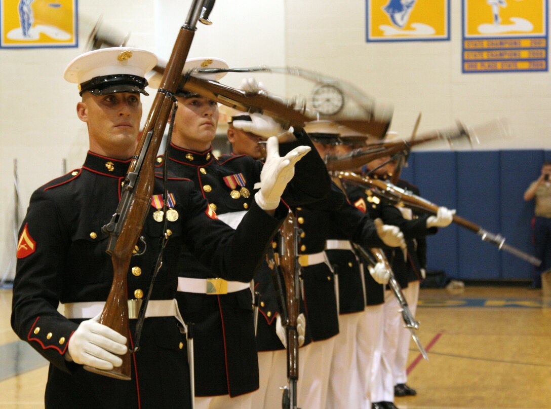 A squad of the U.S. Marine Silent Drill Platoon does an exhibition performance during a drill competition hosted by Recruiting Station St. Louis and judged by U.S. Marine Corps Silent Drill Platoon members April 16 at Seckman High School.