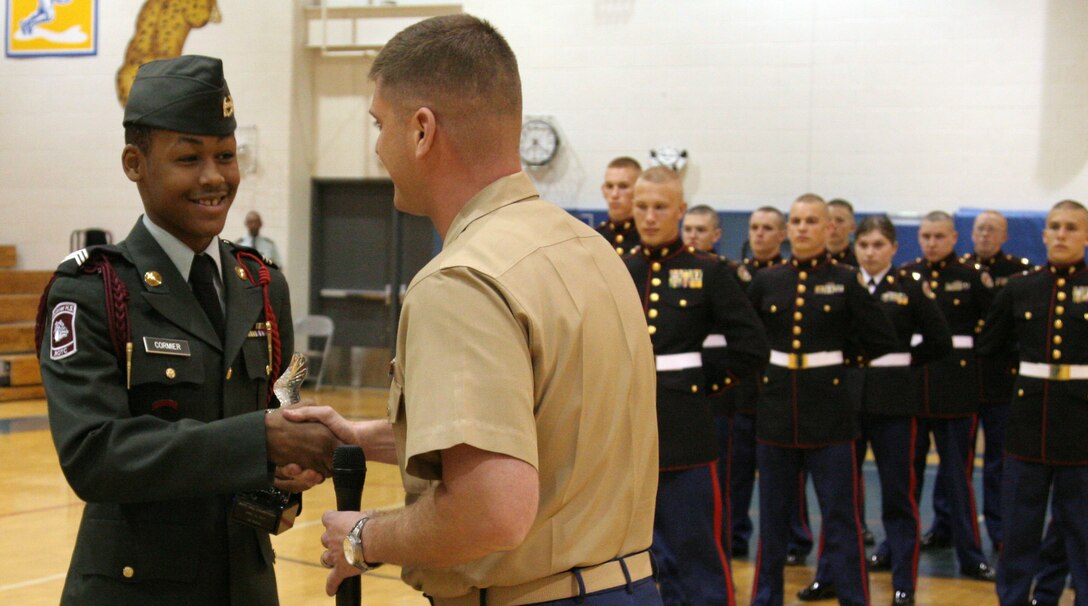 Cadet Charles Cormier accepts the first place trophy for the Sumner High School Army JROTC platoon during a drill competition hosted by Recruiting Station St. Louis and judged by U.S. Marine Corps Silent Drill Platoon members April 16 at Seckman High School. Cormier is the platoon commander of Sumner’s JROTC.