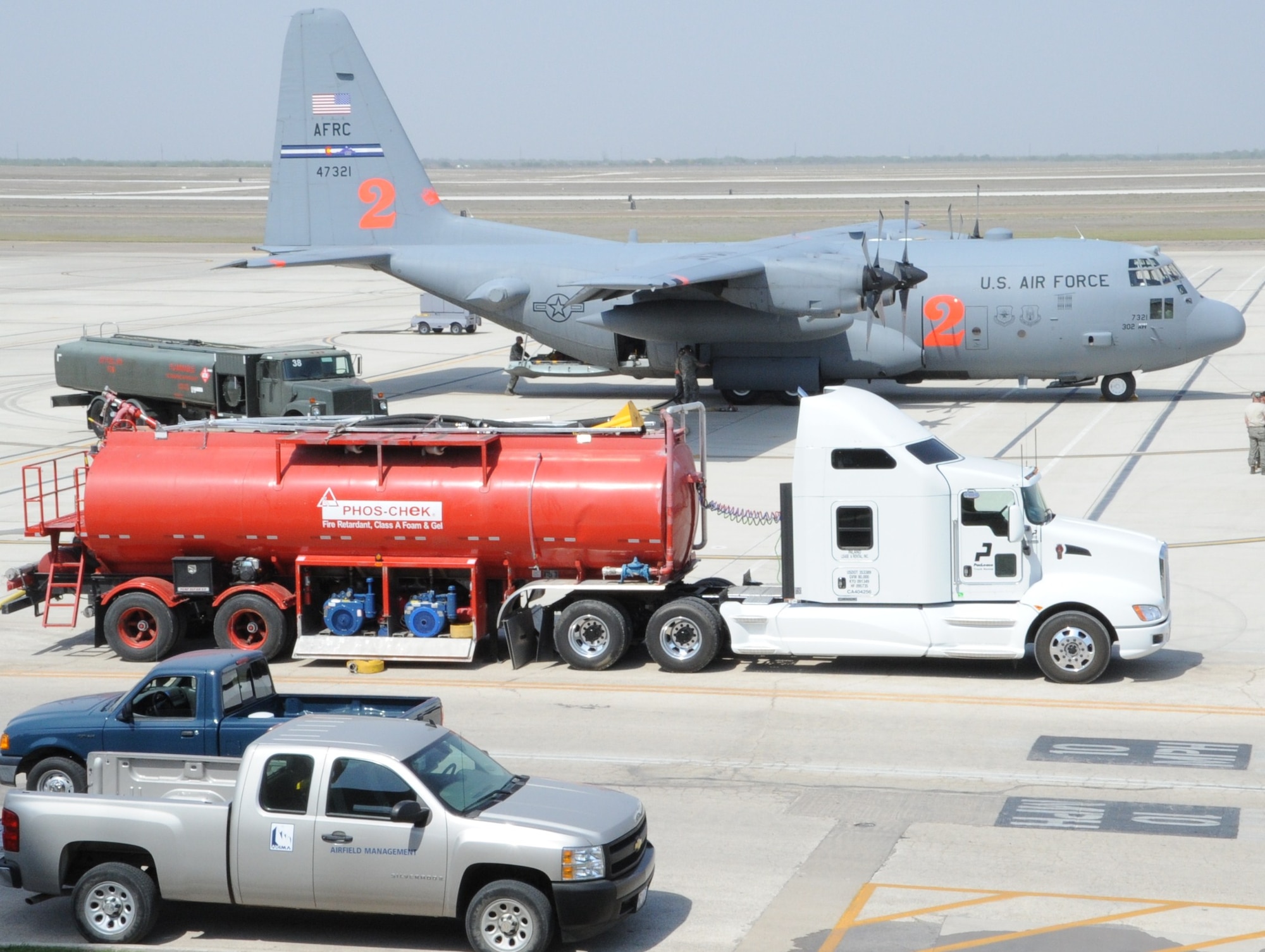LAUGHLIN AIR FORCE BASE, Texas — Maintenance crewmembers from the 302nd Airlift Wing at Peterson Air Force Base, Colo., prepare a C-130 here today to conduct an aerial fire fighting mission over Coahuila, Mexico. Two C-130s, deployed by U.S. Northern Command to Laughlin at the request of the Mexican government, dropped approximately 12,000 gallons of fire suppressant today on the wildfires that have burned more than 245,000 acres in Coahuila. (U.S. Air Force photo by Airman 1st Class Blake Mize)