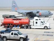 LAUGHLIN AIR FORCE BASE, Texas — Maintenance crewmembers from the 302nd Airlift Wing at Peterson Air Force Base, Colo., prepare a C-130 here today to conduct an aerial fire fighting mission over Coahuila, Mexico. Two C-130s, deployed by U.S. Northern Command to Laughlin at the request of the Mexican government, dropped approximately 12,000 gallons of fire suppressant today on the wildfires that have burned more than 245,000 acres in Coahuila. (U.S. Air Force photo by Airman 1st Class Blake Mize)