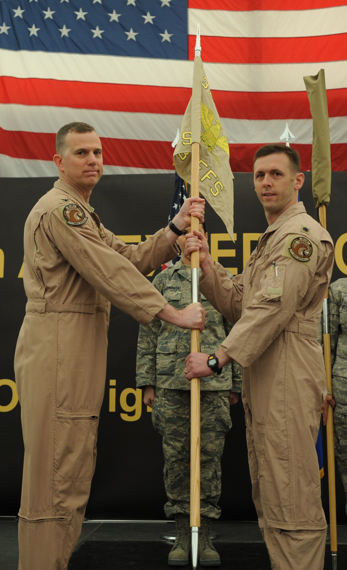 Col. Gregory Guillot, 380th Expeditionary Operations Group commander, presents the squadron guidon flag to the new 493rd Expeditionary Fighter Squadron commander, Lt. Col. Skip Pribyl, during the activation ceremony April 11, 2011. Colonel Pribyl is deployed from the 493rd Fighter Squadron, Royal Air Force Lakenheath, United Kingdom. (U.S. Air Force photo by Senior Airman Maynelinne De La Cruz)