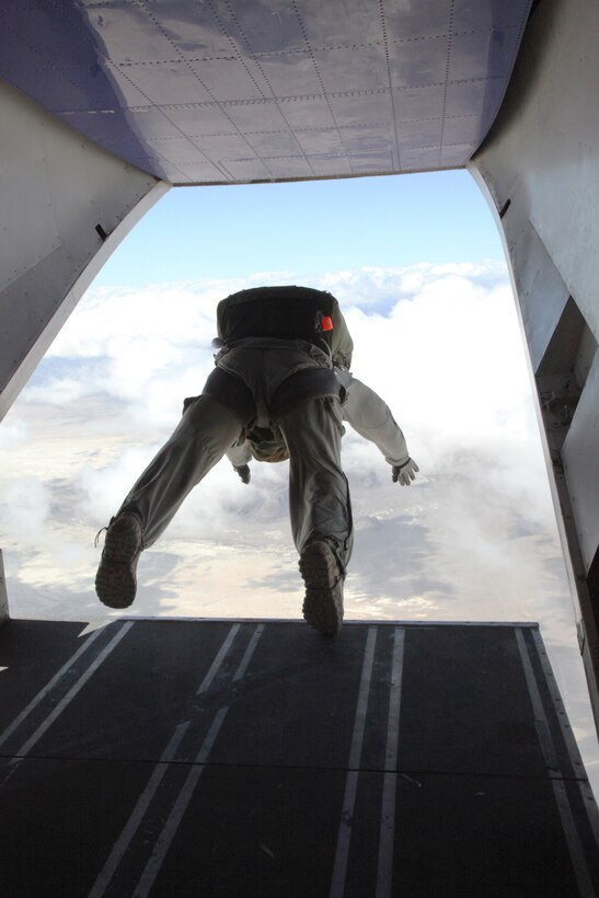 A jumpmaster with U.S. Marine Corps Forces, Special Operations Command, dives out of a plane during a Double-Bag Static-Line parachute course in Wendover, Utah, April 9 - 21. The course was taught by personnel from the 2nd MSOB paraloft and the Airborne Mobile Training Team, and is designed to give Marines a basic understanding of HAHO operations.