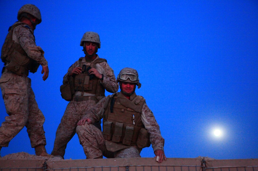 Lance Cpl. Ryan A. Golder, Petty Officer 2nd Class Justin M. Mullins, Lance Cpl. Wade E. Skaff, all with Marine Wing Support Squadron 272, are helping to improve a new forward arming refueling point at Combat Outpost Ouellette in Afghanistan’s Helmand province, April 17. The forward arming refueling point was recently constructed at the combat outpost to enable 2nd Marine Aircraft Wing (Forward) to better support Marines and other coalition troops operating near Sangin, Afghanistan Golder is a bulk fuel specialist, Mullins is a corpsman and Skaff is a motor transport specialist. “When we are done building the fuel bladders they will hold 40,000 gallons of fuel,” said Golder. “It will help our overall mission out here of supporting the helicopters that fly in to fuel up.”