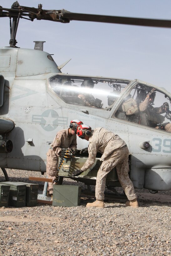 Cpl. Reagan M. Odhner and Cpl. Brian A. Winkler, aviation ordnance technicians with Marine Light Attack Helicopter Squadron 169, load ammunition onto an AH-1W Cobra at a new forward arming refueling point at Combat Outpost Ouellette in Afghanistan’s Helmand province, April 17. “I love my job; you can’t do what I do anywhere else,” said Odhner, a native of Philadelphia. The forward arming refueling point was recently constructed at the combat outpost to enable 2nd Marine Aircraft Wing (Forward) to better support Marines and other coalition troops operating near Sangin, Afghanistan.