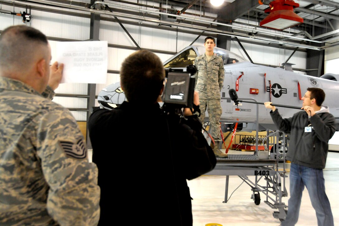 Airman 1st Class Robert Pedzinski is filmed in front of an A-10 Warthog on April 16, 2011 in Ft. Wayne, Ind.  Pedzinski was filmed by the Ft. Wayne Tincaps, a local minor league baseball team.  He introduced the national anthem and the footage will be played on the big screen at the team's home games.  (Photo by USAF Staff Sgt. Justin Goeden) RELEASED