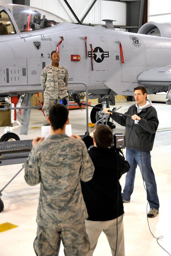 Airman 1st Class Sharane Watson is filmed in front of an A-10 Warthog on April 16, 2011 in Ft. Wayne, Ind.  Watson was filmed by the Ft. Wayne Tincaps, a local minor league baseball team.  She introduced the national anthem and the footage will be played on the big screen at the team's home games.  (Photo by USAF Staff Sgt. Justin Goeden) RELEASED