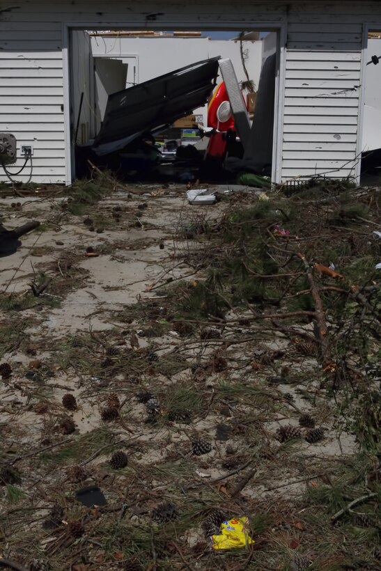 The driveway of one of the Tarawa Terrace housing community residences aboard Marine Corps Base Camp Lejeune sits littered with tree branches and other debris following the Saturday night tornado, April 15. This house, along with approximately 10 others, was completely demolished, the families that occupied them now living with friends or staying in hotel rooms.