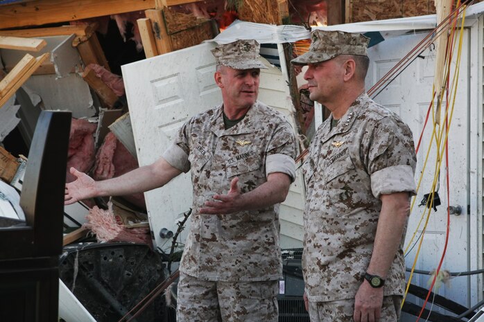 Maj. Gen. Carl Jensen (left), commanding general of Marine Corps Installations – East, explains the path of Saturday night’s tornado to Gen. James Cartwright, vice chairman of the Joint Chiefs of Staff, among the wreckage of one of the demolished houses aboard the Tarawa Terrace housing community, Marine Corps Base Camp Lejeune, April 15. Cartwright was briefed prior to viewing the wreckage by Col. Daniel Lecce, commanding officer of MCB Camp Lejeune, explaining how the displaced families are being cared for and the clean-up efforts occurring aboard the housing community.