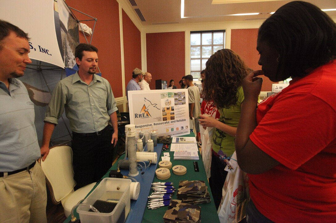 Middle school students look on as employees with RHEA engineering talk to the students about  how water is filtered, during the Earth Day Expo at Marston Pavilion, MCB Camp Lejeune, April 18. Earth Day was celebrated aboard the base and this year focused on recycling, renewable energy and the environment.