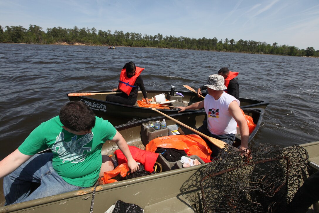 Volunteers with the White Oak New Riverkeeper Alliance and service members pick up trash along the Northeast Creek aboard Marine Corps Base Camp Lejeune, during Earth Day, April 18. Along with picking up trash the base also hosted the Earth Day Expo to raise awareness.