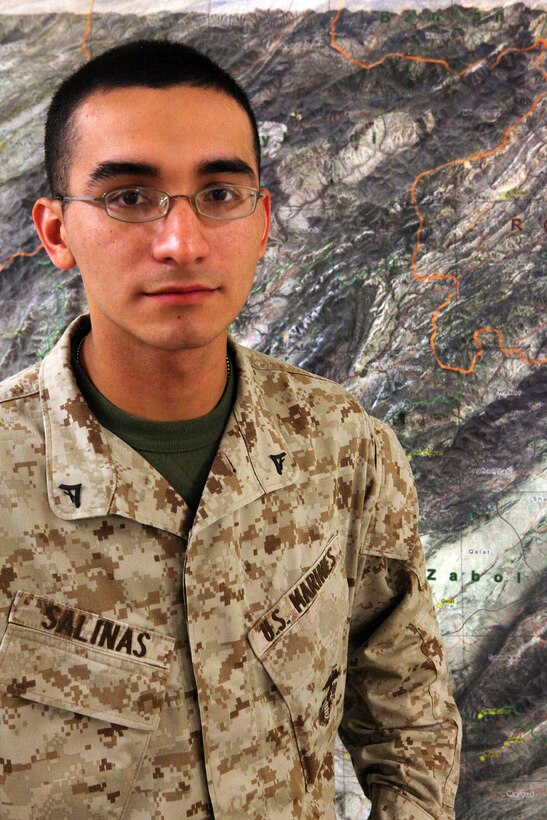 Lance Cpl. Ivan Salinas, a McAllen, Texas, native, stands in front of a map of the Islamic Republic of Afghanistan April 18.  The 20-year-old Nikki Rowe High School graduate is a Marine Air Ground Task Force planner for 2nd Marine Division (Forward) and is deployed to Camp Leatherneck, Helmand province, in support of Operation Enduring Freedom.  Salinas has been instrumental in the control and accountability of more than 2,000 Marines and Sailors and their gear.  That’s more than 100 flights going in and out of Afghanistan carrying around 88,000 pounds of cargo.  (Photo by Cpl. Marco Mancha)