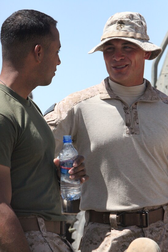 (left) Cpl. David Reinoso, a bulk fuel specialist with Marine Wing Support Squadron 272 listens as Staff Sgt. Rockey L. Crump, the forward arming and refueling point at Combat Outpost Ouellette officer in charge with MWSS-272, talks at Combat Outpost Ouellette near Sangin, Afghanistan, April 18. “I know all of the Marines’ goals and ambitions and I try to help them reach those things,” said Crump. “To me being a leader means being firm with your Marines but also being flexible to fit their needs. This is all part of being a Marine.”