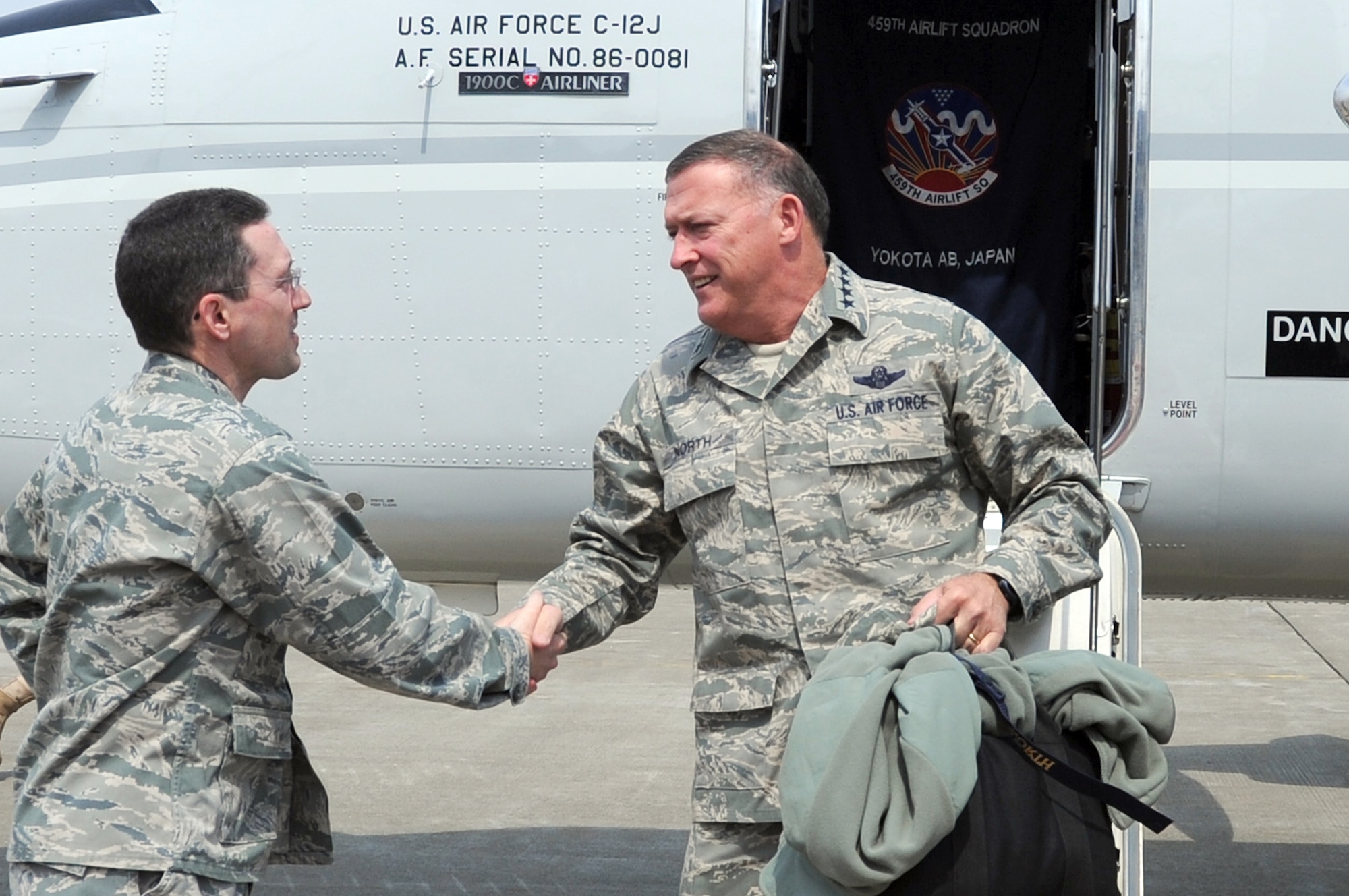 MISAWA AIR BASE, Japan --  Gen. Gary North, Pacific Air Forces commander, is greeted by Col. Michael Rothstein, 35th Fighter Wing commander, April 15. During the visit General North talked with Airmen and visited areas affected by the earthquake. (U.S. Air Force photo by Staff Sgt. Marie Brown\Released)