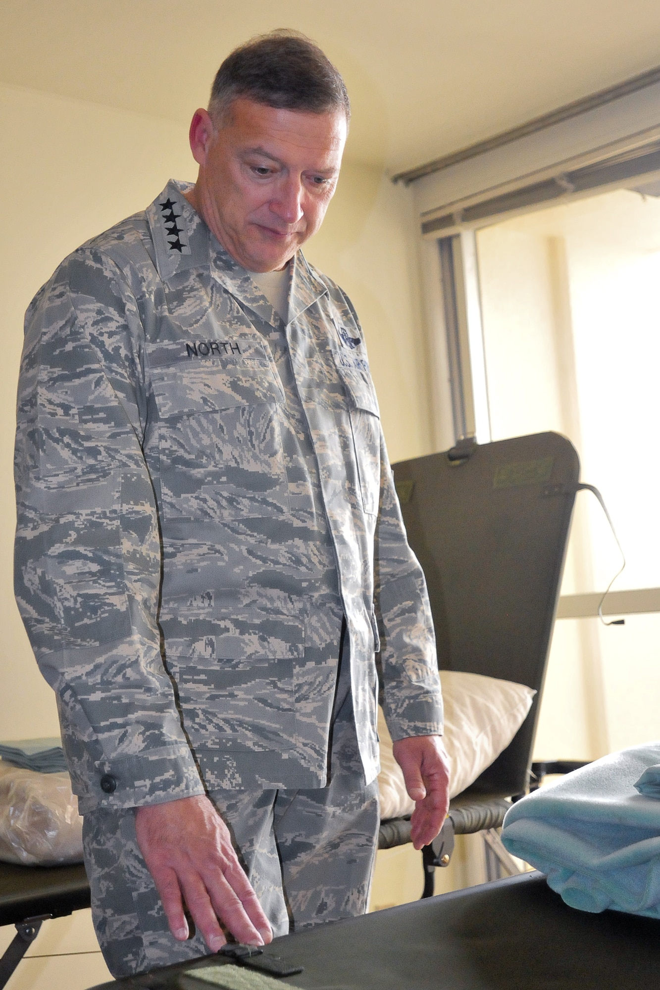 YOKOTA AIR BASE, Japan -- Gen. Gary North, Pacific Air Forces commander, observes the sleeping arrangements for personnel that are temporarily stationed at Yokota Air Base in support of Operation Tomodachi, April 18. General North visited Yokota Air Base to thank Airmen for their support in Operation Tomodachi . (U.S. Air Force photo/Airman 1st Class Krystal M. Garrett)  