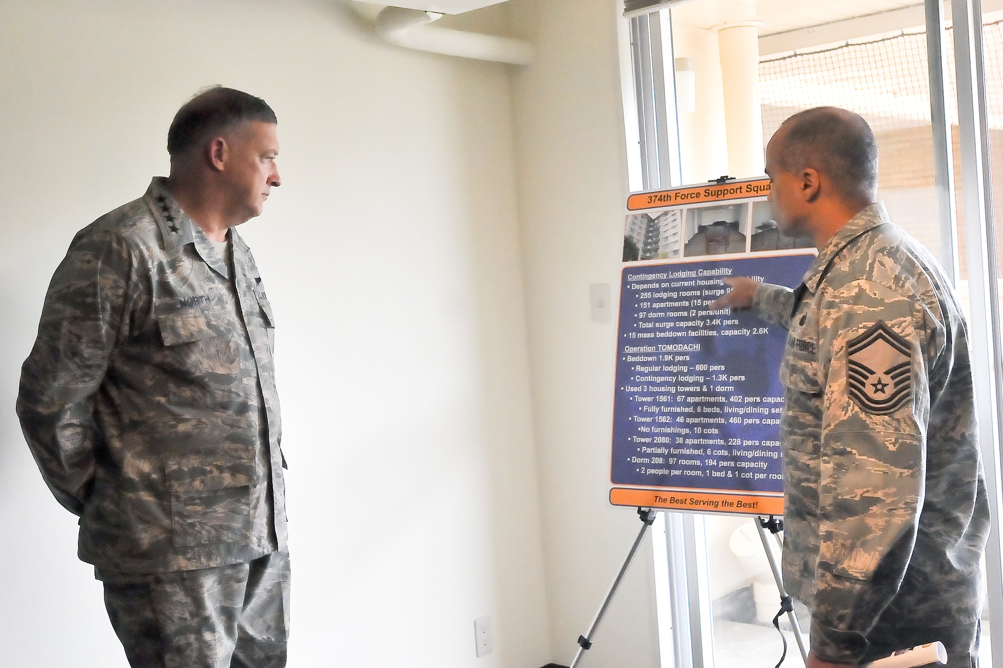 YOKOTA AIR BASE, Japan -- Senior Master Sgt. Rabin Ramsook, 374th Force Support Squadron, explains the living arrangements that were made to accommodate personnel deployed to support Operation Tomodachi to Gen. Gary North, Pacific Air Forces commander, at Yokota Air Base, Japan April 18. (U.S. Air Force photo/Airman 1st Class Krystal M. Garrett) 