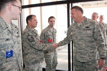 YOKOTA AIR BASE, Japan -- General Gary North, Pacific Air Forces commander, shakes hands with Master Sgt. Lucas Buchholz (center), 730th Air Mobility Squadron, at the AMC passenger terminal here April 17. General North visited Yokota Air Base to thank Airmen for their efforts in support of Operation Tomodachi. (U.S. Air Force photo/Osakabe Yasuo)