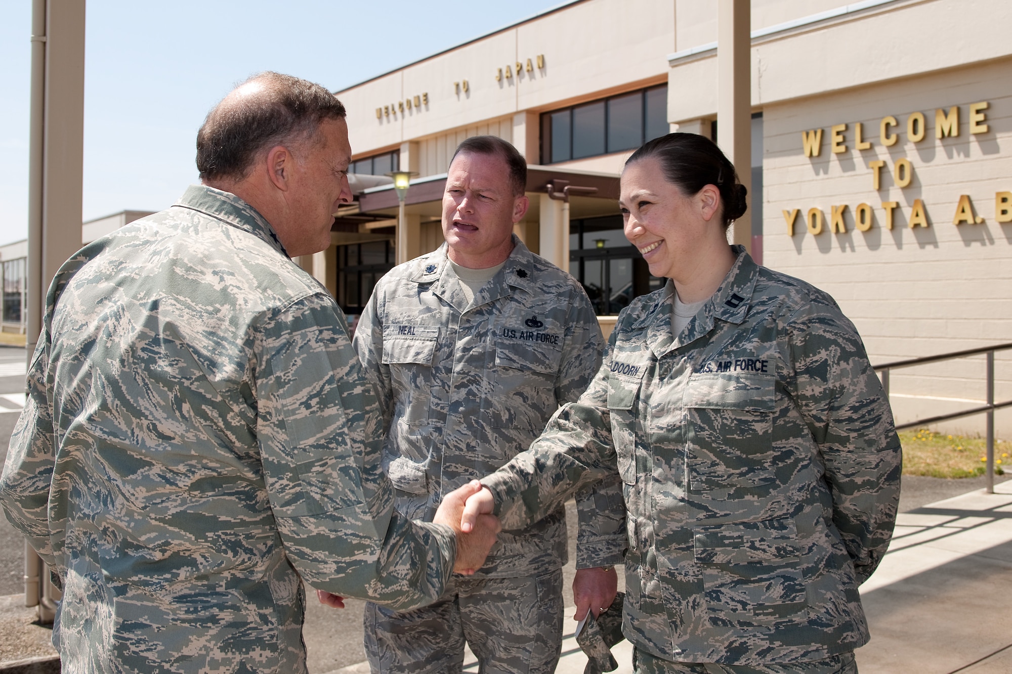 YOKOTA AIR BASE, Japan -- General Gary North, Pacific Air Forces commander, shakes hands with Capt. Laura Apeldoorn, a member of the 730th Air Mobility Squadron, at the AMC passenger terminal April 17. General North visited Yokota Air Base to thank Airmen for their efforts in support of Operation Tomodachi. (U.S. Air Force photo/Osakabe Yasuo)
