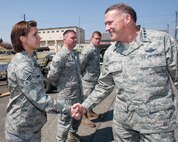 YOKOTA AIR BASE, Japan -- General Gary North, Pacific Air Forces commander, shakes hands with Senior Airman Sarah Bishop, a member of the 374th Logistics Readiness Squadron, at the Petroleum, Oils, and Lubricants yard April 17. General North visited Yokota Air Base to thank Airmen for their efforts in support of Operation Tomodachi. (U.S. Air Force photo/Osakabe Yasuo)