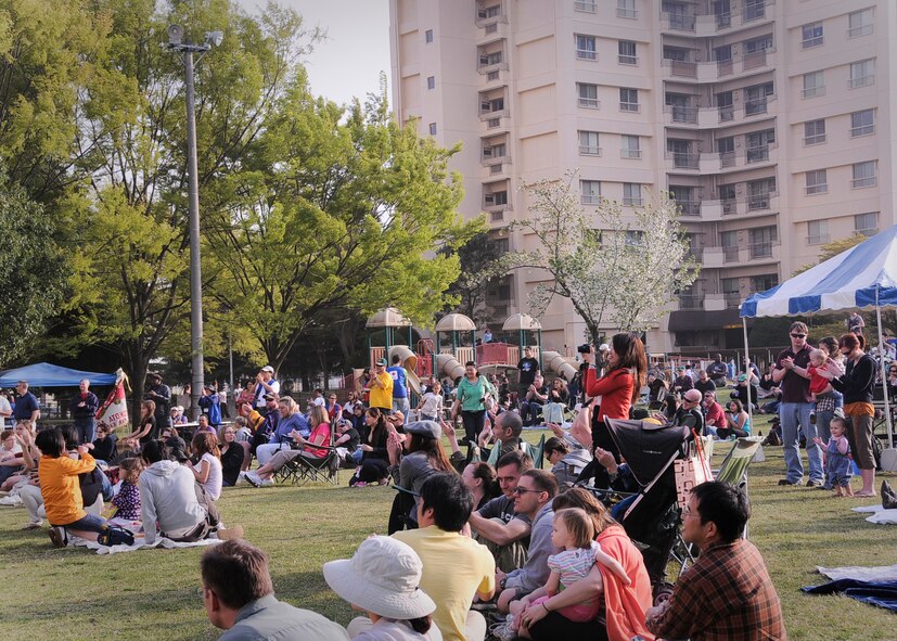 YOKOTA AIR BASE, Japan -- Yokota members watch as the rock band, Days Gone By, performs a variety of songs on stage during Tomodachi Stock 2011 here April 16. More than 700 people gathered at Yokota's Sakura Shell to enjoy music, friendship and food while helping the American Red Cross raise money to support the earthquake and tsunami relief efforts. (U.S. Air Force photo/Senior Airman Andrea Salazar)