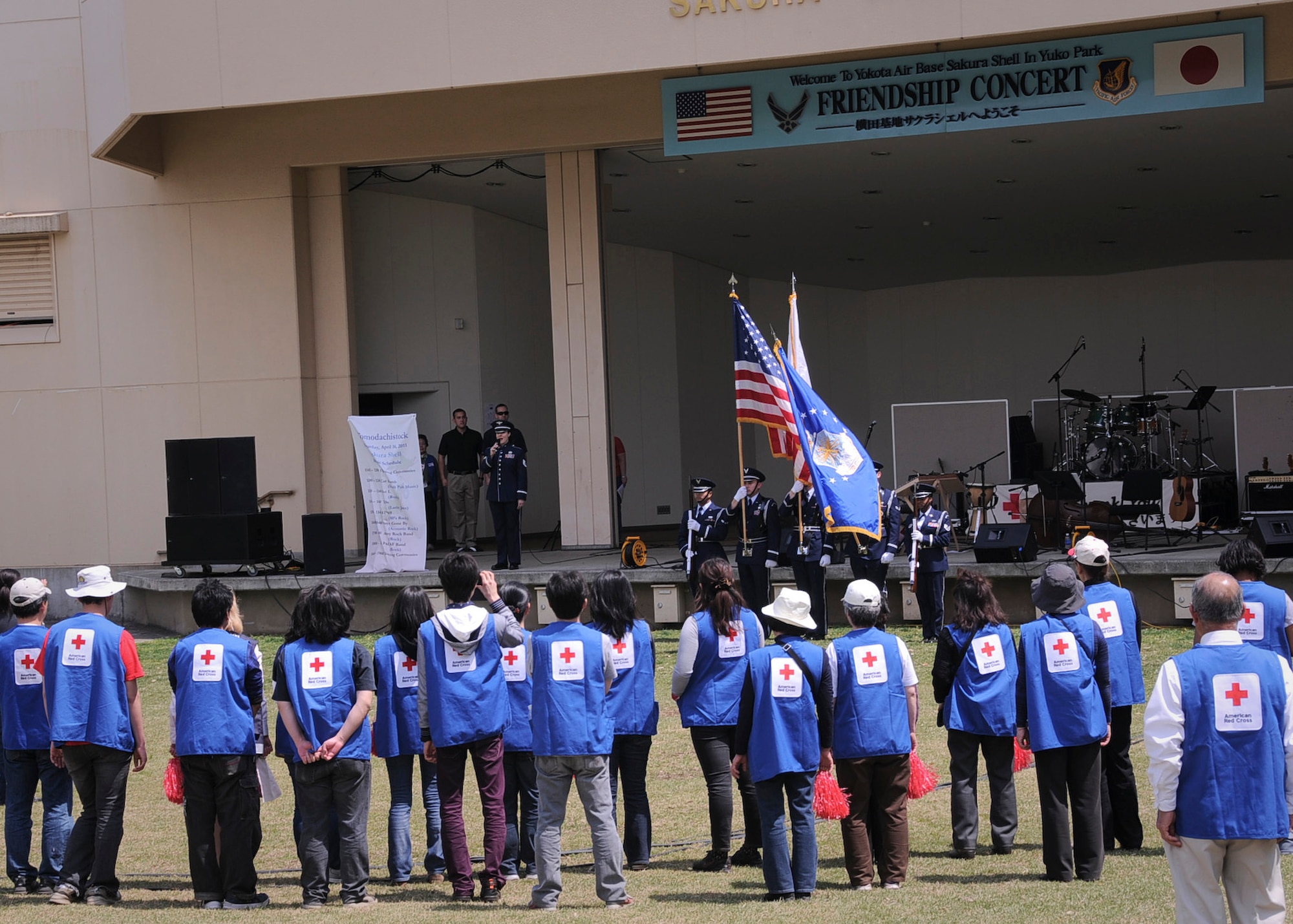 YOKOTA AIR BASE, Japan -- American Red Cross volunteers stand during the opening ceremony during Tomodachi Stock 2011 here April 16. Tomodachi Stock was a free benefit concert designed to provide a venue for Yokota residents to donate to the American Red Cross. More than 40 Red Cross volunteers put in 407 hours to help make the event a success. (U.S. Air Force photo/Senior Airman Andrea Salazar)
