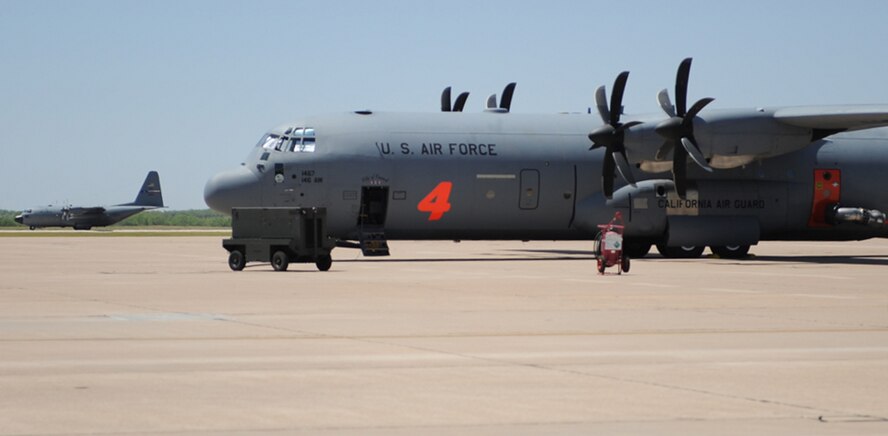 Airmen from California Air National Guard's 146th Airlift Wing, North Carolina Air National Guard's 145th Airlift Wing and Wyoming Air National Guard's 153rd Airlift Wing gather at Dyess Air Force Base, Texas to prepare for wildfire fighting operations April 18. The Airmen maintain and operate the Modular Airborne Firefighting System (MAFFS) housed aboard a C-130 Hercules capable of dispensing 3,000 gallons of water or fire retardant in under 5 seconds. The wildfires have spread across various parts of Texas and have burned more than 1,000 square miles of land. (U.S. Air Force Photo/Airman 1st Class Shannon Hall)