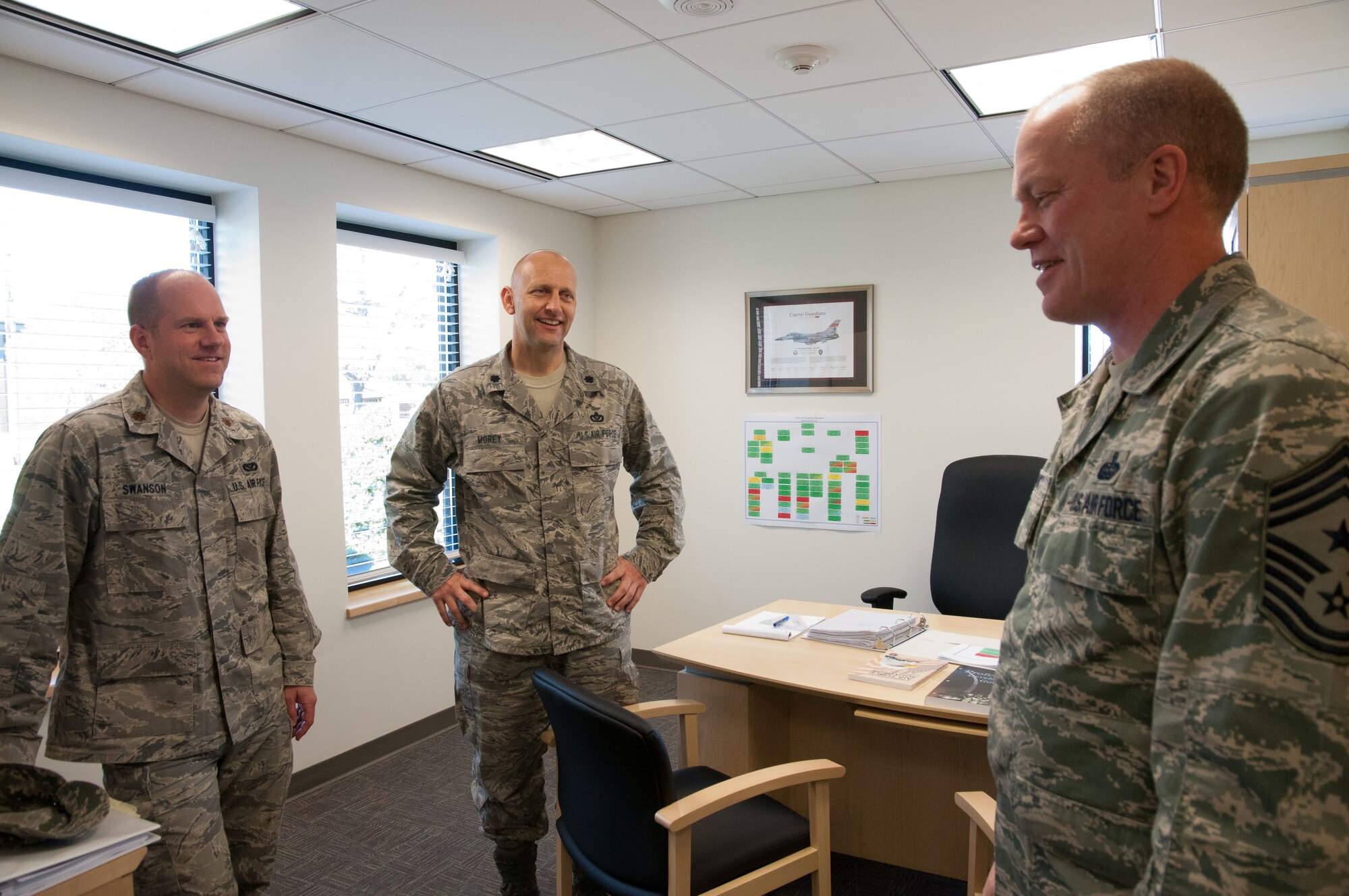 Command Chief Master Sgt. Christopher Muncy, Air National Guard Command Chief Master Sergeant, talks with Major Eric Swanson and Lt. Col. Robin Morey from the 113th Civil Engineering Squadron during a visit to the District of Columbia Air National Guard, April 17, 2011. The Command Chief was invited to talk with Airmen of the unit as well as visit different work areas to get a better idea of the 113th Wing mission. (U.S. Air Force photo by Master Sgt. Dennis Young)