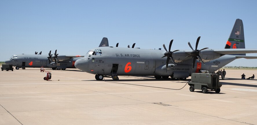 Airmen from California Air National Guard's 146th Airlift Wing, North Carolina Air National Guard's 145th Airlift Wing and Wyoming Air National Guard's 153rd Airlift Wing gather at Dyess Air Force Base, Texas to prepare for wildfire fighting operations April 18. The Airmen maintain and operate the Modular Airborne Firefighting System (MAFFS) housed aboard a C-130 Hercules capable of dispensing 3,000 gallons of water or fire retardant in under 5 seconds. The wildfires have spread across various parts of Texas and have burned more than 1,000 square miles of land. (U.S. Air Force Photo/Airman 1st Class Shannon Hall)