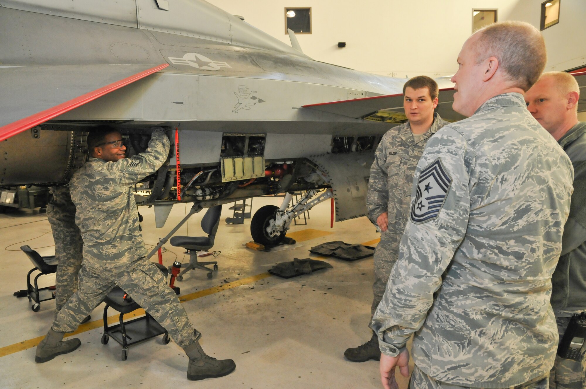 Chief Master Sgt. Christopher Muncy, Air National Guard Command Chief Master Sergeant, talks with TSgt. Willson and SSgt. Byron from the 121st Fighter Squadron during a visit to District of Columbia Air National Guard, April 17,2011. The Chief was invited to talk to the airman of the unit as well as to visit different workspaces to get a better idea of the 113th Wing mission. (U.S. Air Force photo/Master. Sgt. Dennis Young)