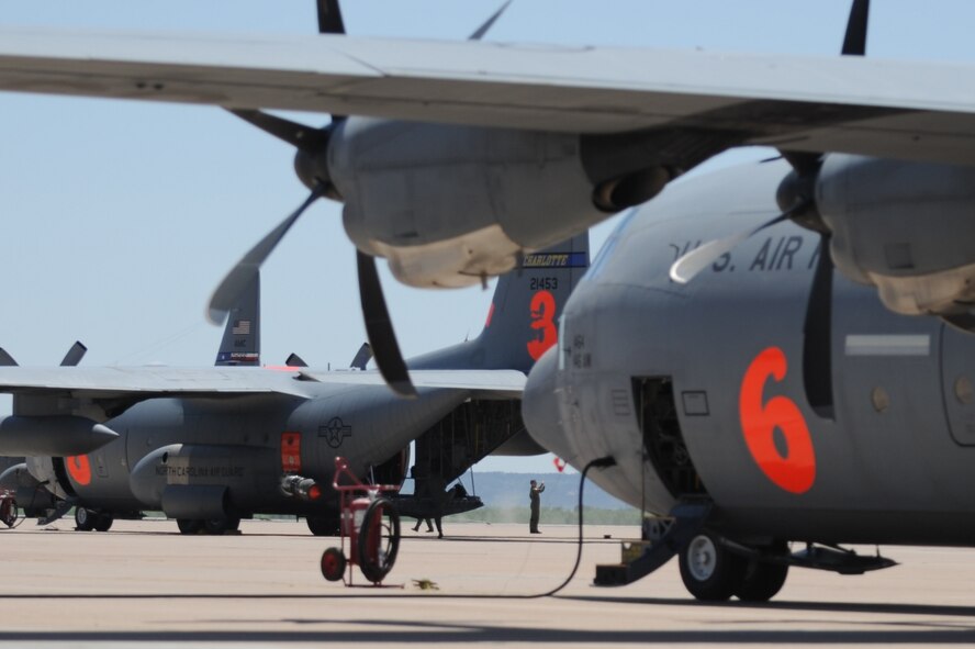 Airmen from California Air National Guard's 146th Airlift Wing, North Carolina Air National Guard's 145th Airlift Wing and Wyoming Air National Guard's 153rd Airlift Wing gather at Dyess Air Force Base, Texas to prepare for wildfire fighting operations April 18. The Airmen maintain and operate the Modular Airborne Firefighting System (MAFFS) housed aboard a C-130 Hercules capable of dispensing 3,000 gallons of water or fire retardant in under 5 seconds. The wildfires have spread across various parts of Texas and have burned more than 1,000 square miles of land.  (U.S. Air Force Photo/Tech. Sgt. Robert Wollenberg)