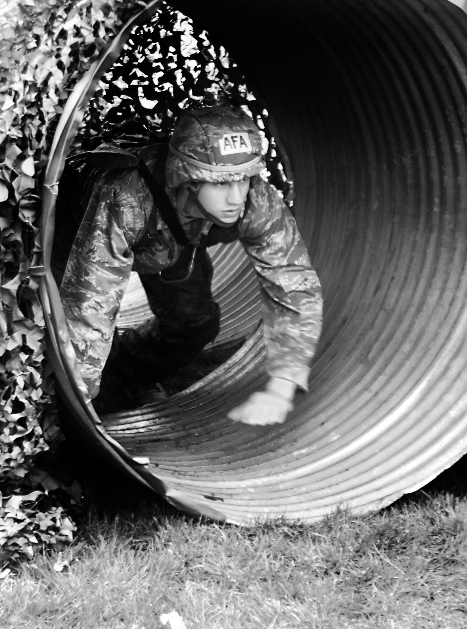 Cadet 1st Class Andrew Owens pushes through one of the final obstacles during the Sandhurst Competition Saturday, April 16, 2011 at the U.S. Military Academy, N.Y.  The competition requires each team to perform a series of challenging military tasks along a 7-mile route, and compete in a marksmanship competition.  The team only had a rough idea of what to train for as most of the challenges were kept secret until the day of the event.  (U.S. Air Force photo/Staff Sgt. Raymond Hoy)