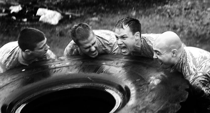 Members of the Air Force Sandhurst team try to flip a large tire across roughly 50 yards during the Sandhurst Competition Saturday, April 16, 2011 at the U.S. Military Academy, N.Y.  The competition requires each team to perform a series of challenging military tasks along a 7-mile route, and compete in a marksmanship competition.  The team only had a rough idea of what to train for as most of the challenges were kept secret until the day of the event.  (U.S. Air Force photo/Staff Sgt. Raymond Hoy)