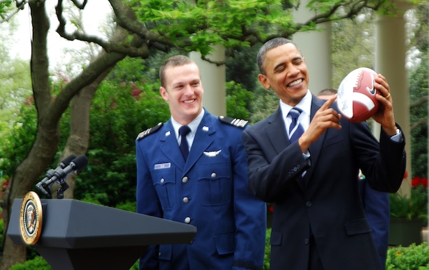 President Barack Obama receives a Falcons football from fullback Jared Tew after presenting the 2010 Air Force Academy football team with the Commander-in-Chief's Trophy at the White House Monday, April 18, 2011.  This is the 17th time the Falcons have won the trophy and the first since 2002.  (U.S. Air Force photo/Staff Sgt. Raymond Hoy)