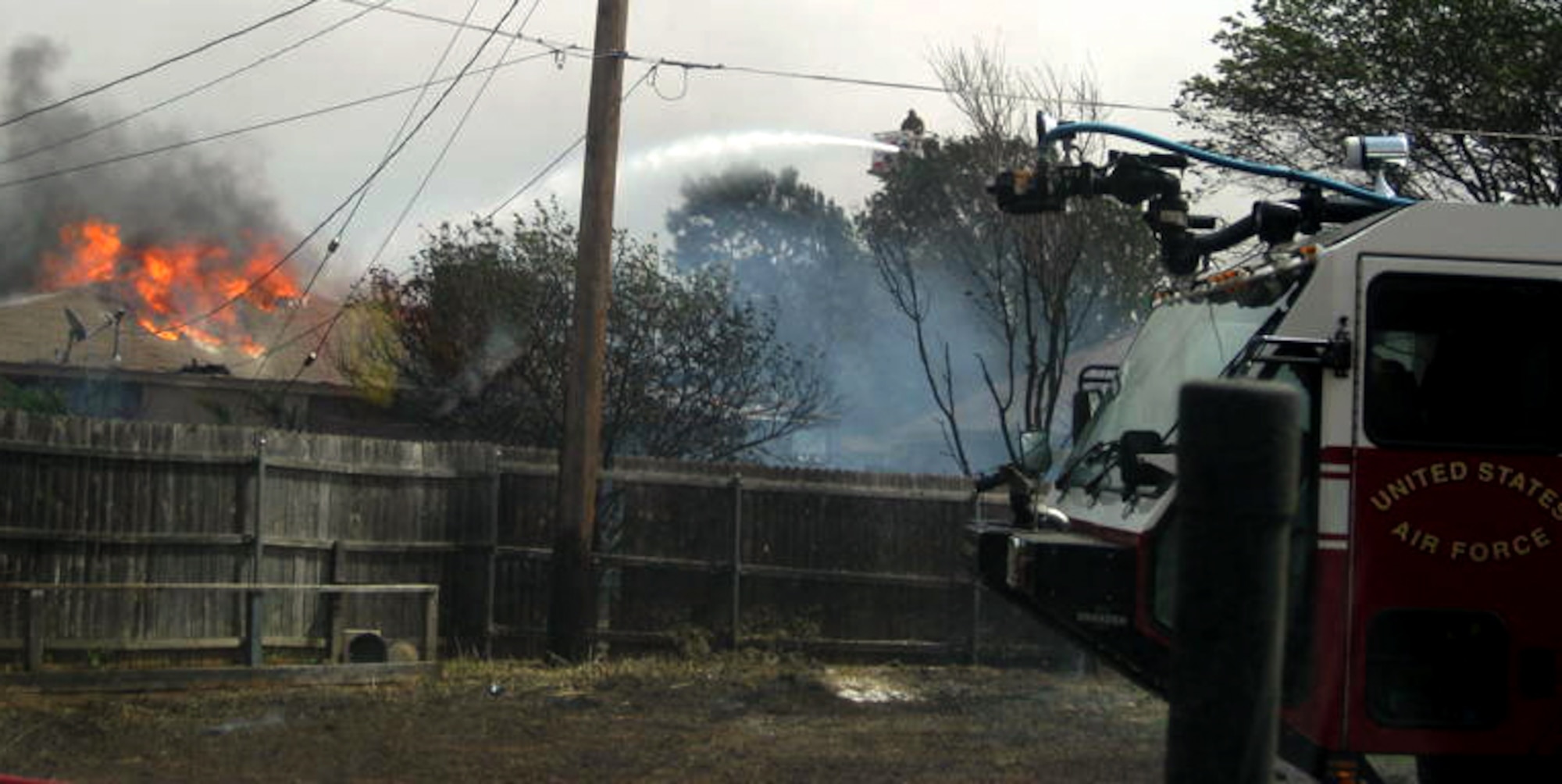 SHEPPARD AIR FORCE BASE, Texas -- Sheppard Air Force Base provided 19 firefighters and eight trucks to help battle wildfires near the base April 15. By deploying "crash" trucks from the airfield, the Sheppard crews were able to put water on the fires quickly and get the fires under control. Three homes were destroyed,
including the home of a Sheppard Airman, but no one was hurt and officials say the damage could have been much worse without Sheppard's assistance. (Courtesy photo)
