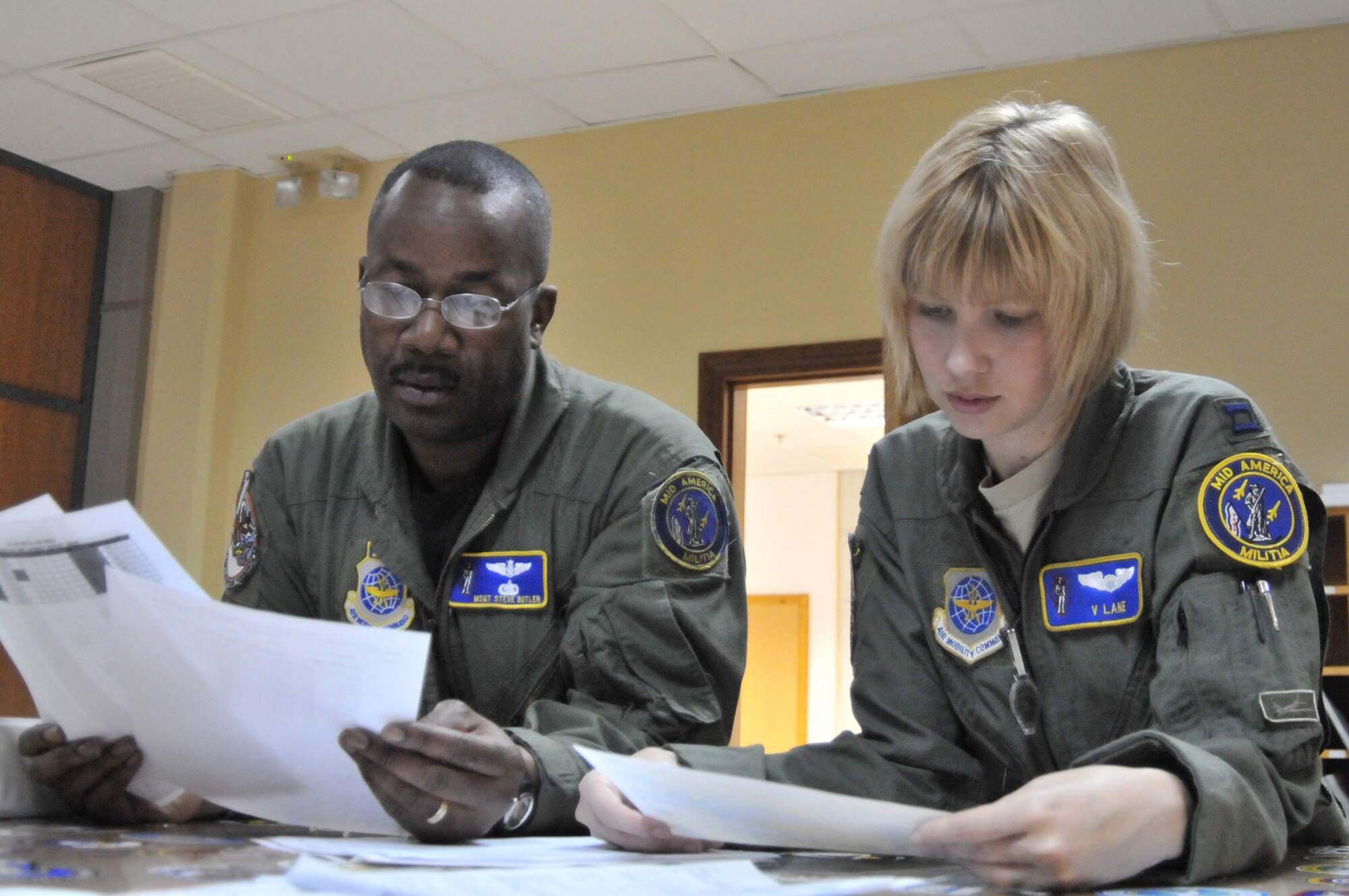 Master Sgt. Steve Butler and Capt. Viveca Lane discuss a refueling mission in support of Operation Unified Protector, a NATO-led mission in Libya to protect civilians and civilian-populated areas under threat of attack. The 313th Air Expeditionary Wing provides aerial refueling to U.S. and coalition aircraft with KC-135 Stratotankers and KC-10 Extenders. Sergeant Butler is an in-flight refueling boom operator. Captain Lane is a KC-135 Stratotanker pilot. (U.S. Air Force photo/Senior Airman David Dobrydney)