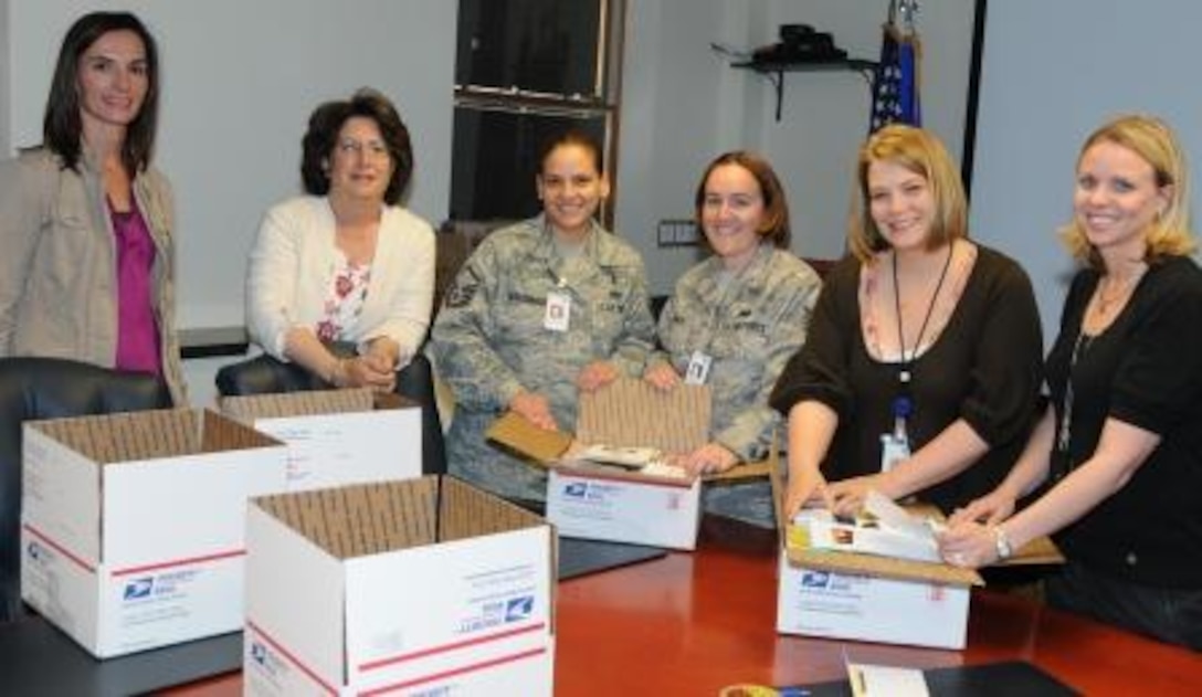 Air Force Operational Test and Evaluation Center members gather with members of the AFOTEC Key Spouse Program to put together quarterly care packages for deployed team members. (Left to right) Denise Eck, Anita Eichhorn, Master Sgt. Susan Maldonado, Technical Sgt. Maria Smith, Brandi Miller, and Stephanie Griffin.