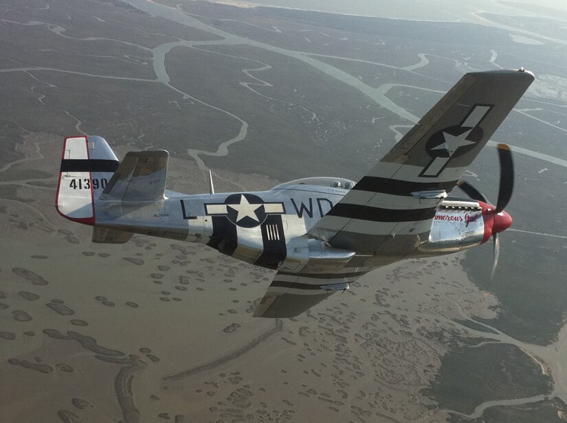 Bill Davenport, a U.S. Marine Corps veteran, takes a ride in a World War II P-51 Mustang with Warrior Flight Team pilot Dale "Snort" Snodgrass April 8, 2011, during the Charleston Air Expo 2011 Family Day events at Joint Base Charleston, S.C.  The Warrior Flight Team travels to different air shows across the country raising awareness for Warrior Aviation and providing support to disabled veterans. (U.S. Air Force photo/2nd Lt. Susan Carlson)