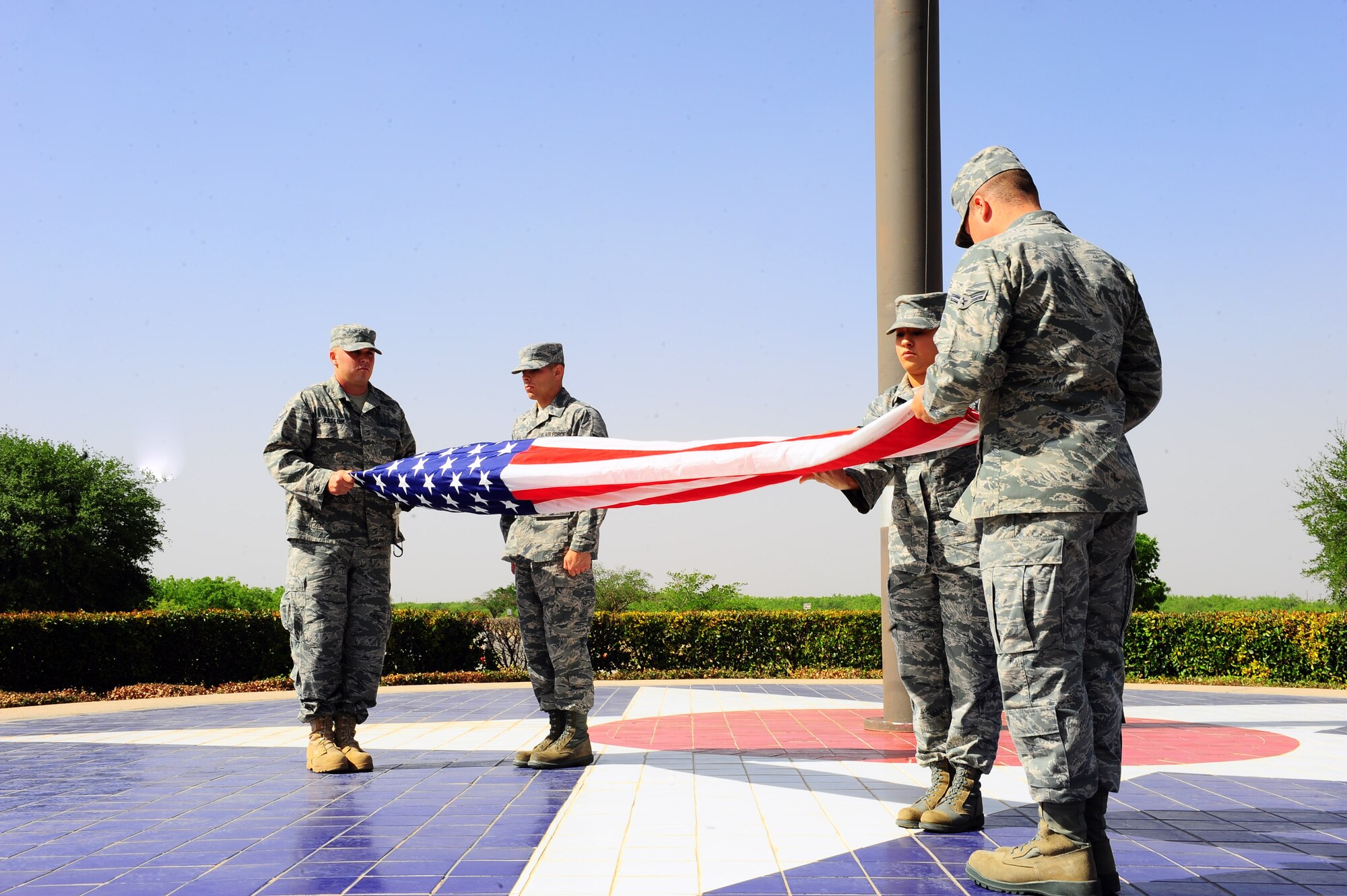 DYESS AIR FORCE BASE, Texas— Dyess Honor Guardsman retire the colors during a retreat ceremony April 15 at the traffic circle here. A retreat ceremony signifies the end of a duty day and is also a way to pay tribute to the American flag. (U.S. Air Force photo/ Airman 1st Class Courtney Moses)