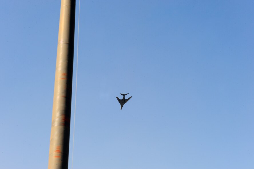 DYESS AIR FORCE BASE, Texas— A Dyess B-1 Bomber performs a fly-over during a retreat ceremony April 15 at the traffic circle here. A retreat ceremony signifies the end of a duty day and is also a way to pay tribute to the American flag. (U.S. Air Force photo/ Airman 1st Class Courtney Moses)