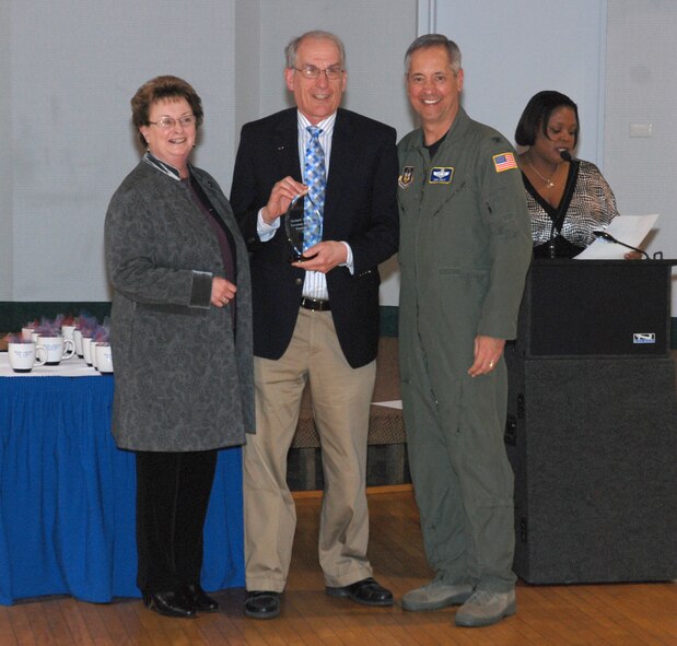 Robert Kazalski, one of more than 40 volunteers honored at the April 15 luncheon at the Westover Club, is honored as the Volunteer of the Year by Col. Robert Swain Jr., 439th Airlift Wing commander. Mr. Kazalski volunteers scores of hours of his time with the base chapel, USO functions, Key Spouse program, and with the Airmen and Family Readiness Center. (US Air Force photo/Airman 1st Class Alexander Brown)