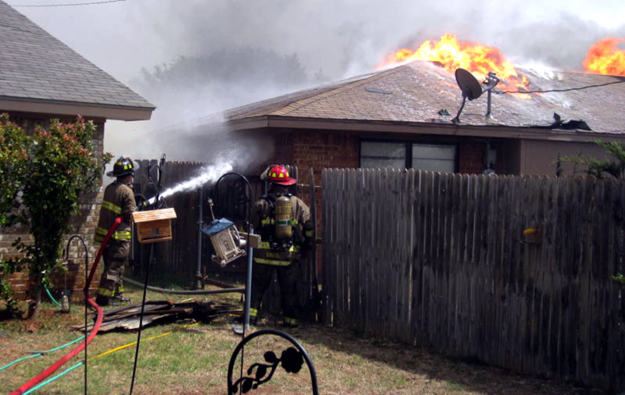 Firefighters work to contain a wildfire that destroyed three homes near Sheppard Air Force Base, Texas, April 15. The base provided 19 firefighters and eight trucks to help battle at least five area wildfires, which were driven by hurricane-force winds and drought conditions. Three homes-one belonging to a Sheppard Airman-were destroyed and the fires forced the evacuation of one of Sheppard's housing areas for several hours.(U.S. Air Force photo/Mike Mckito)
