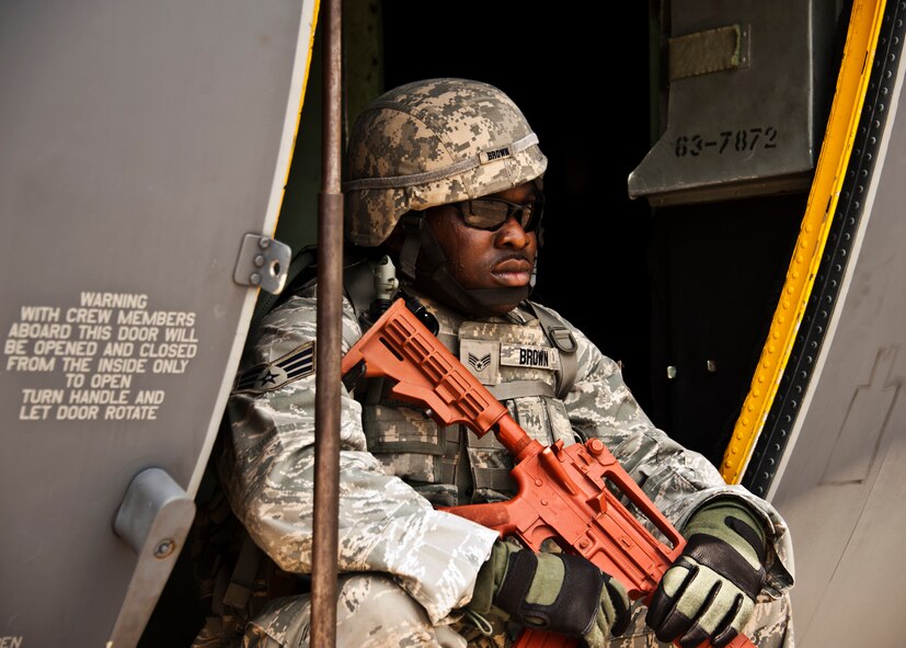 Senior Airman Bobby Brown, 375th Security Forces Squadron, waits by a C-130 for the next scenario to begin during the Fly Away Security Team training session April 14 at Eglin Air Force Base.  The course, taught by 96th Ground Combat Training Squadron instructors, brought together security forces Airmen from all over the U.S. to learn how to protect aircraft and handle potential hostile situations.  (US. Air Force photo/Samuel King Jr.)
