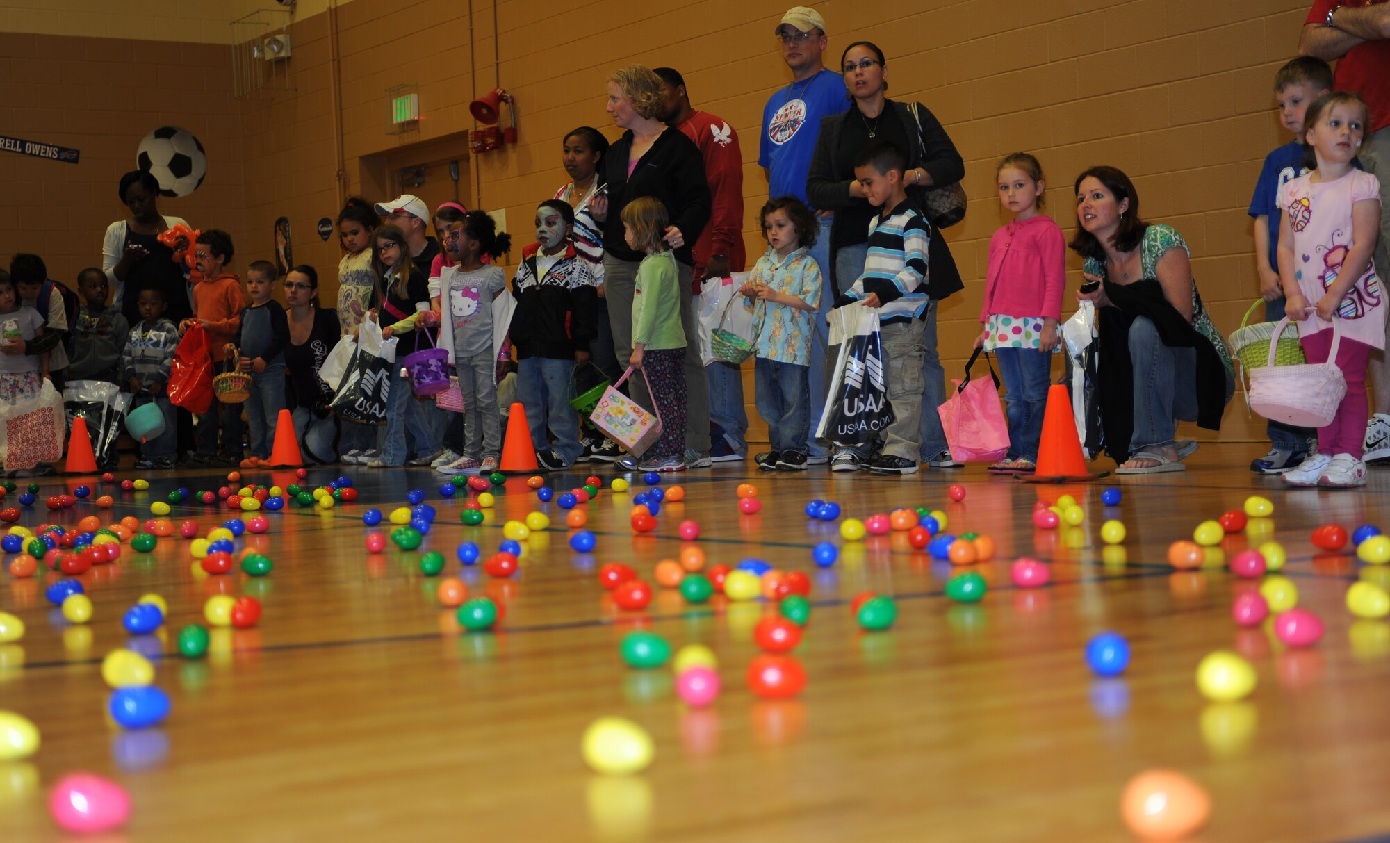 Families wait to begin an Easter egg hunt celebrating  Month of the Military Child during an Extravaganza at Langley Air Force Base, Va., April 16, 2011. Children were divided into age groups and encouraged to collect as many eggs as possible in hope of winning prizes for finding special eggs. (U.S. Air Force photo/Airman 1st Class Teresa Zimmerman/Released)