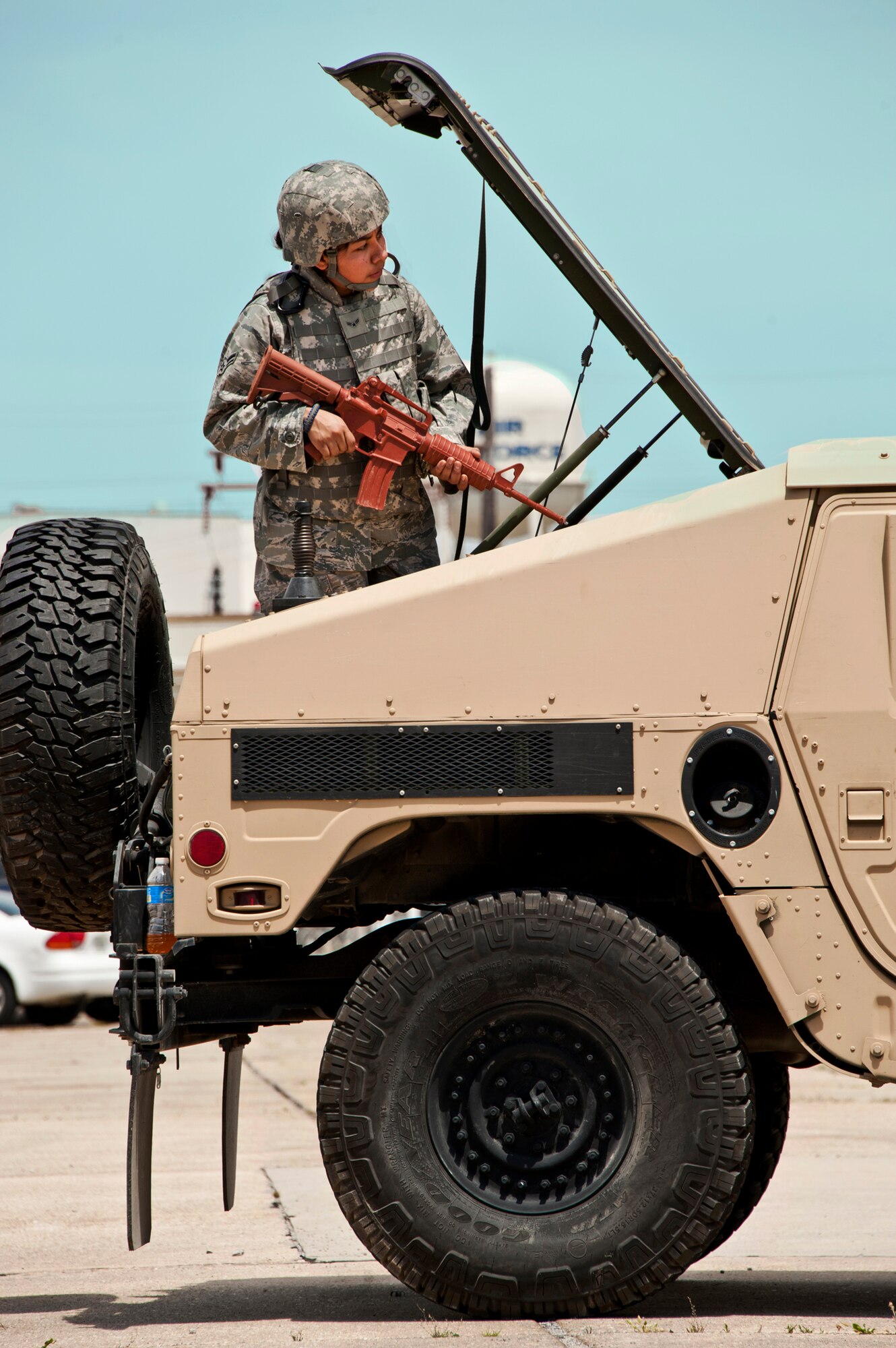 Airman 1st Class Nancy Holguin, 17th Security Force Squadron, watches from the back of a Humvee during a Fly Away Security Team training session April 14 at Eglin Air Force Base.  The course, taught by 96th Ground Combat Training Squadron instructors, brought together security forces Airmen from all over the U.S. to learn how to protect aircraft and handle potential hostile situations.  (US. Air Force photo/Samuel King Jr.)
