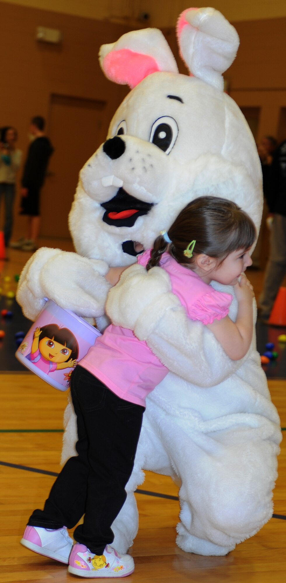 The Easter Bunny hugs Hope Ballesteros, three year old daughter of Staff Sgt Mary Ballesteros, 633d Comptroller Squadron budget analyst, during the Month of the Military Child Extravaganza at Langley Air Force Base, Va., April 16, 2011. Children enjoyed Easter egg hunts, face painting, arts and craft and many other activities at Bethel Manor Youth Center to celebrate. (U.S. Air Force photo/Airman 1st Class Teresa Zimmerman/Released)
