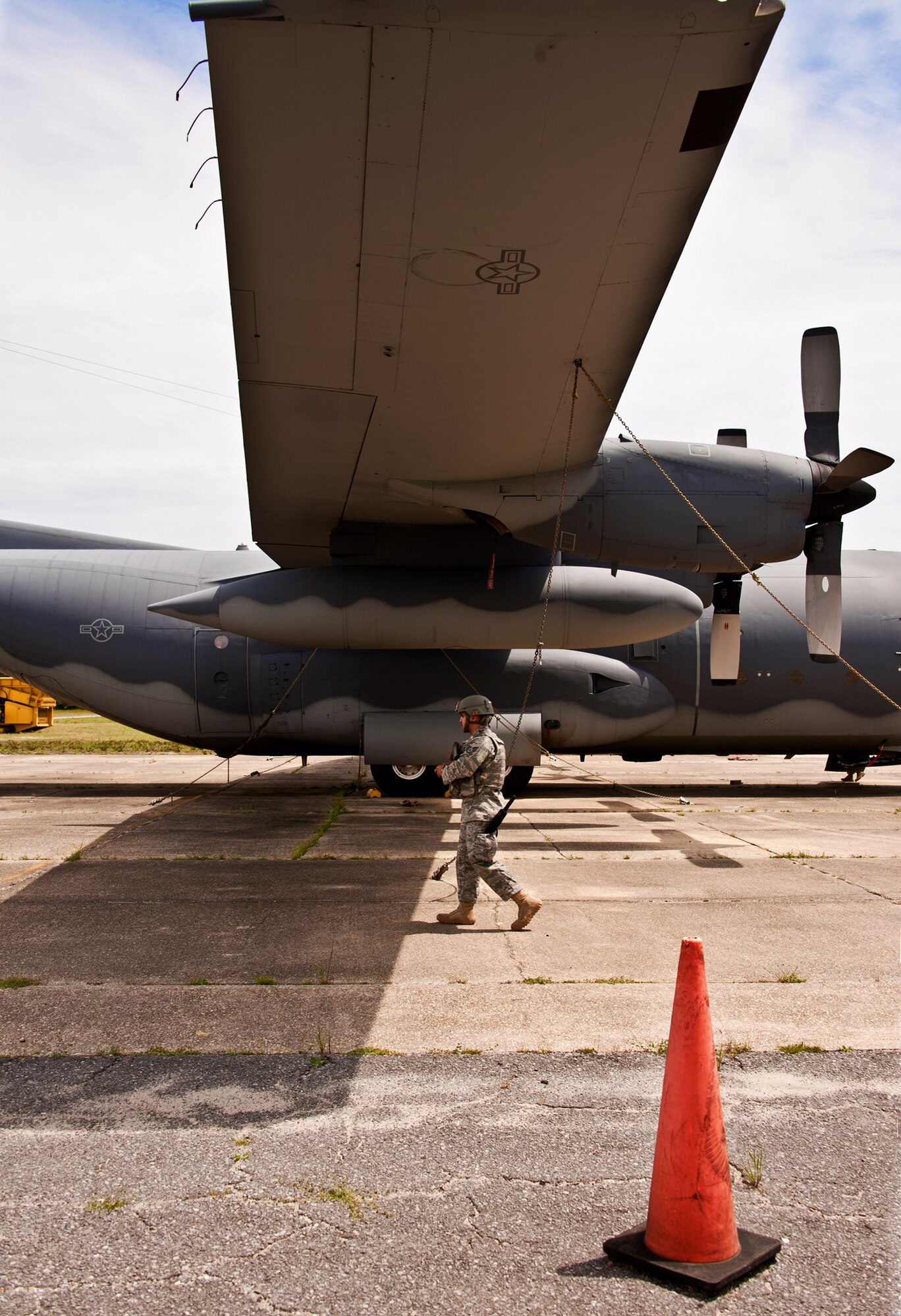 Staff Sgt. Eric Garza, 10th Security Forces Squadron, patrols the right side of the C-130 during a Fly Away Security Team training session April 14 at Eglin Air Force Base.  The course, taught by 96th Ground Combat Training Squadron instructors, brought together security forces Airmen from all over the U.S. to learn how to protect aircraft and handle potential hostile situations.  (US. Air Force photo/Samuel King Jr.)