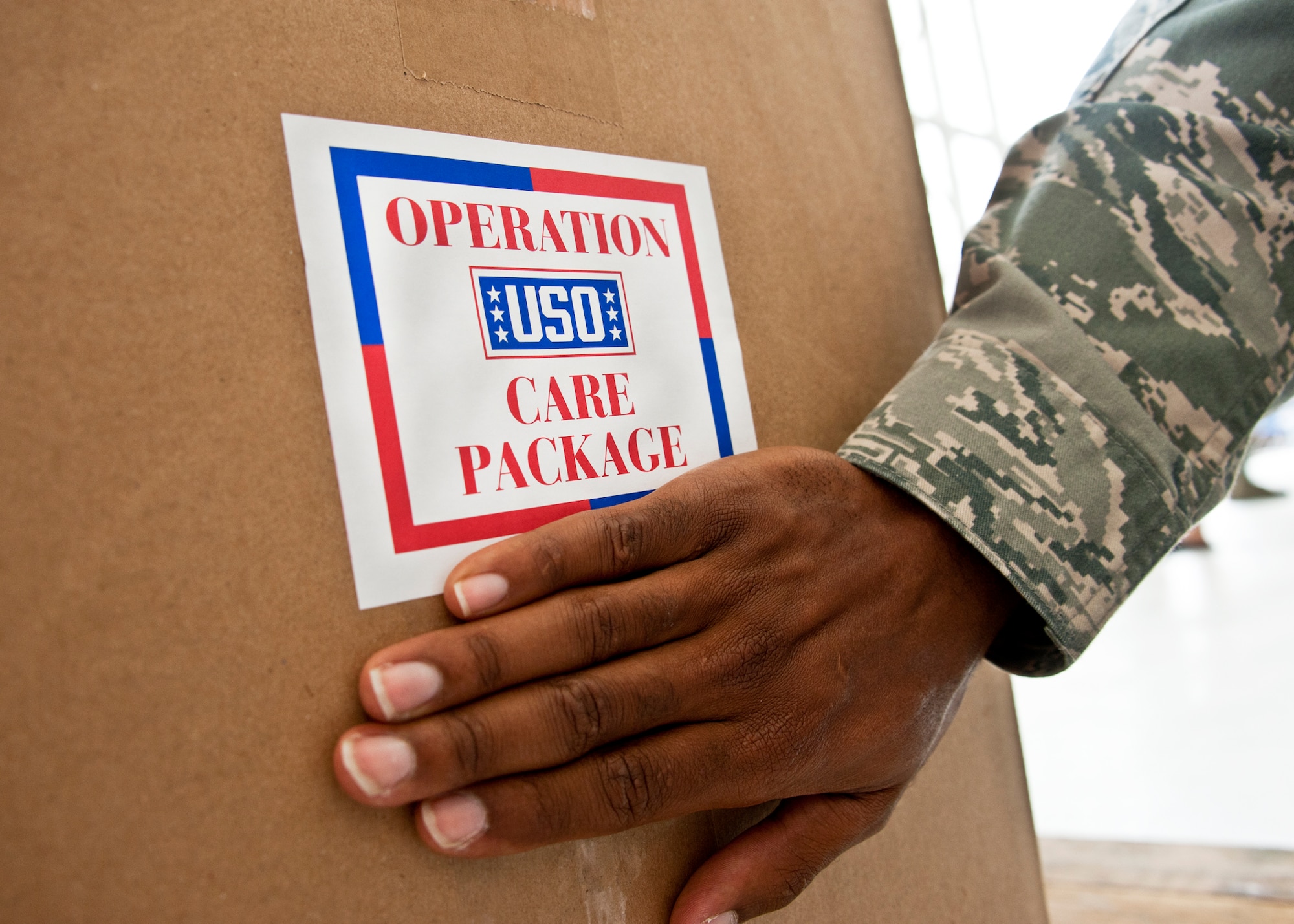 A volunteer puts the label on the box of goodie bags so it is ready for shipment.   More than 180 volunteers participated in the Jack Daniel's/USO Toast to the Troops Program by assembling thousands of Operation USO Care Packages April 15. More than 150,000 care packages have been sent to troops through this program since 2005. (USAF photo/Samuel King Jr.)     

