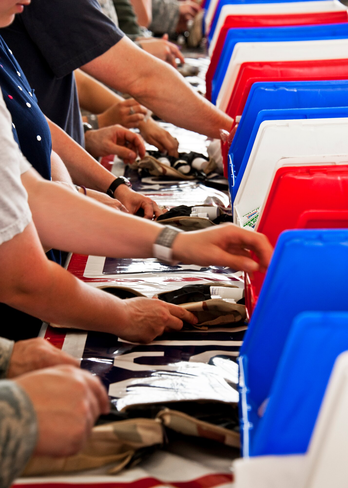 More than 180 volunteers participated in the Jack Daniel's/USO Toast to the Troops Program by assembling thousands of Operation USO Care Packages April 15. More than 150,000 care packages have been sent to troops through this program since 2005. (USAF photo/Samuel King Jr.)     

