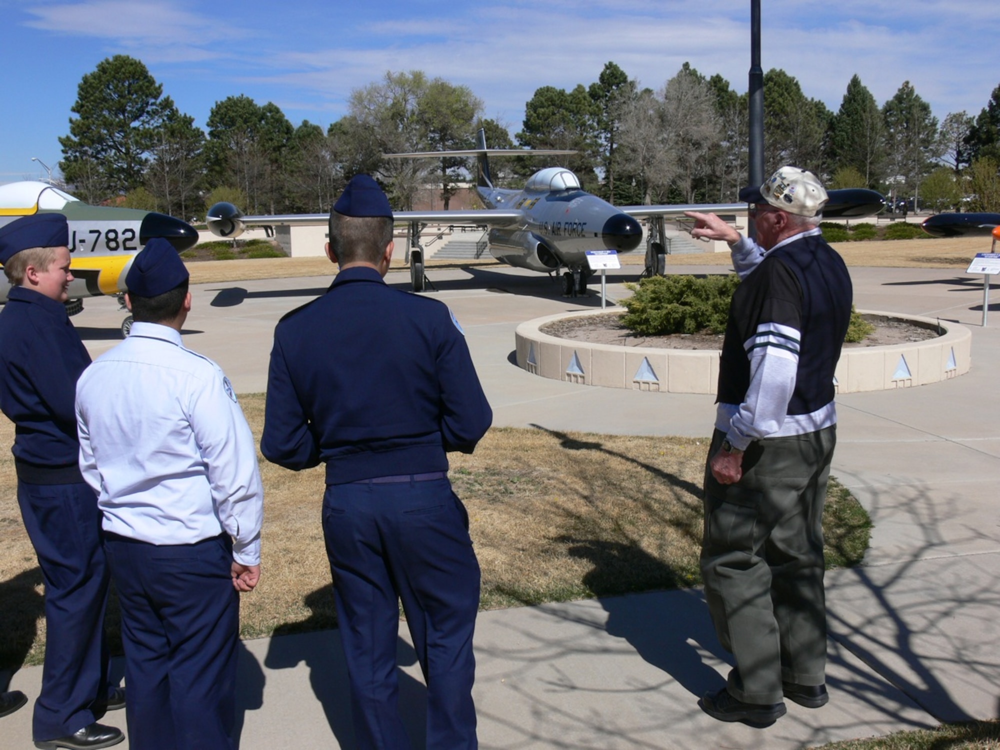 PETERSON AIR FORCE BASE, COLO. – Peterson Air and Space Museum docent Paul Brown gives a tour of 16 historic aircraft to Harrison High School Junior ROTC cadets April 12, 2011. Twenty-five high school cadets and their instructors spent half a day on Peterson AFB touring the aircraft at the 302nd Airlift Wing and watching a demonstration by the 21st Security Forces Squadron Military Working Dog group. The cadets had an opportunity to ask Airmen about their military careers and training. (U.S. Air Force photo/Monica Mendoza)
