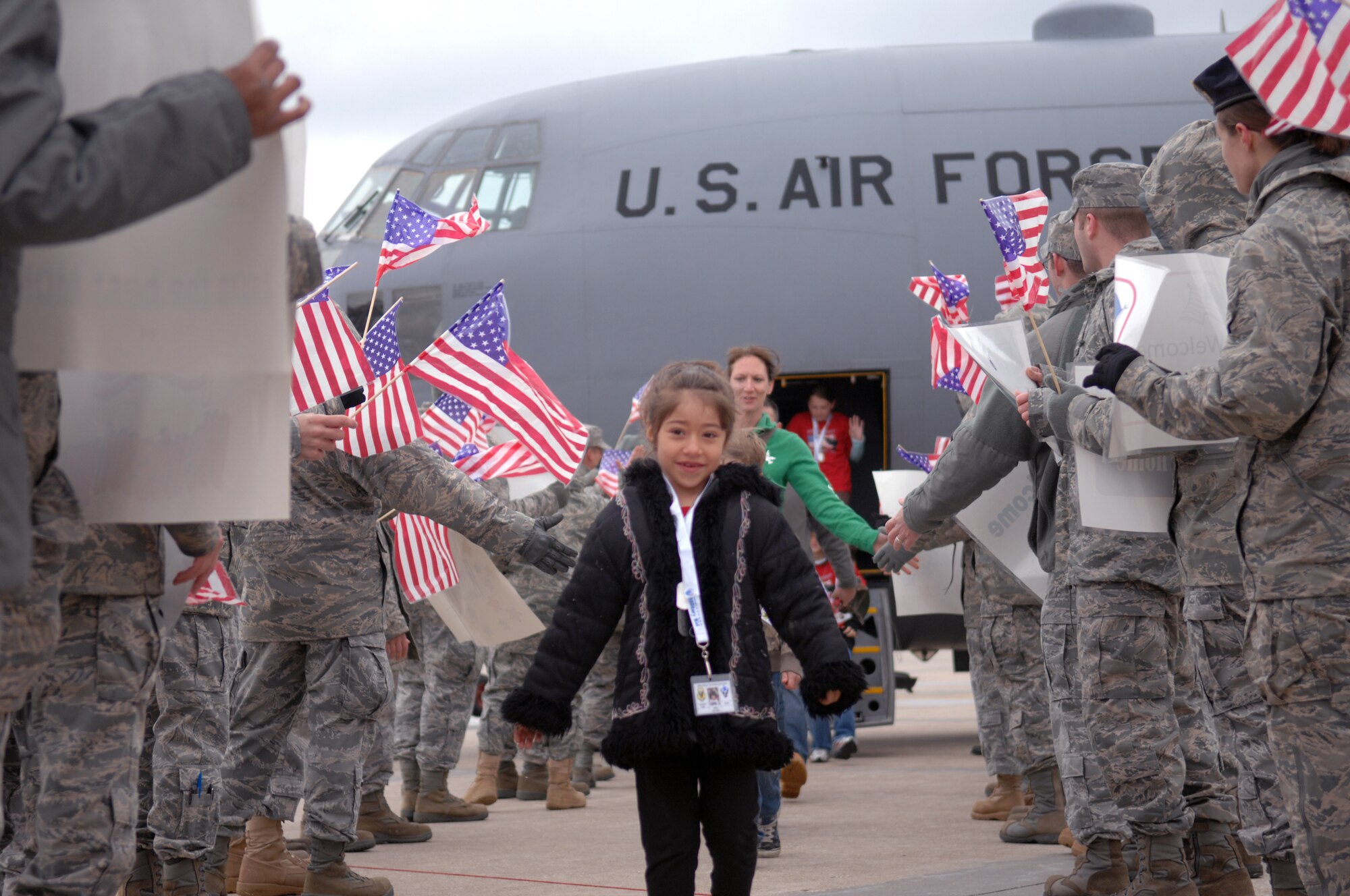 WHITEMAN AIR FORCE BASE, Mo. -- Children returning from their simulated deployment are greeted by a line of Airmen during Operation Spirit April 16, 2011. Operation Spirit is hosted once a year to show military children a piece of what their parents might experience through a deployment.  (U.S. Air Force photo by Airman 1st Class Cody H. Ramirez)
